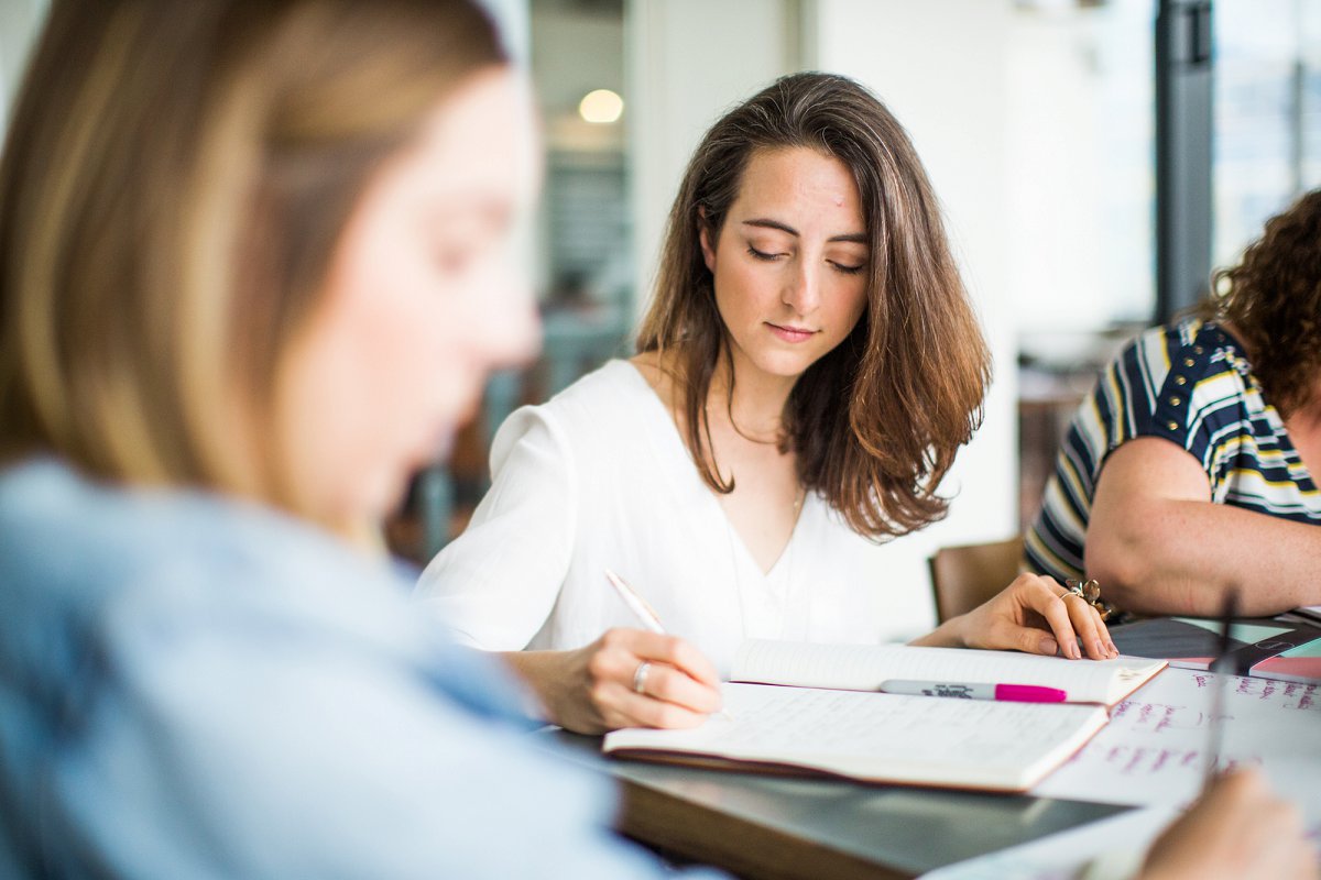 Female business owner taking notes at workshop