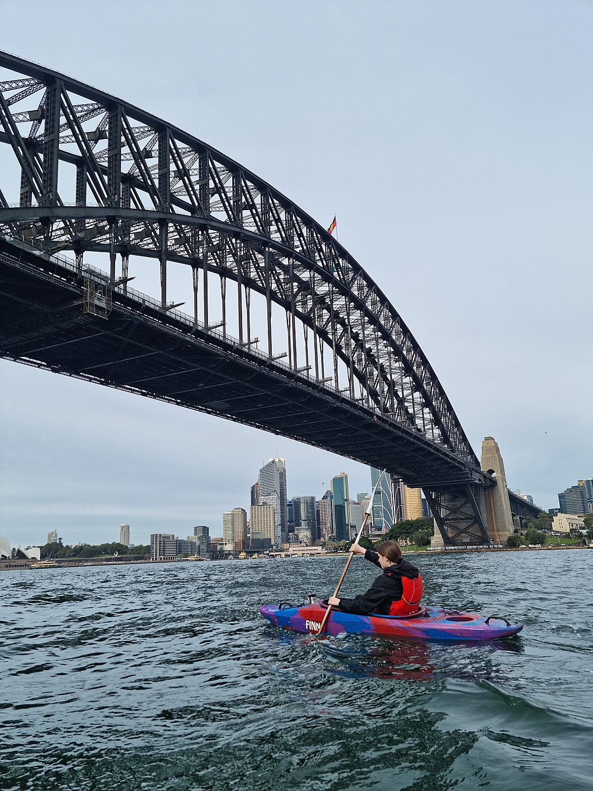 Izzy kayaking below Sydney Harbour Bridge